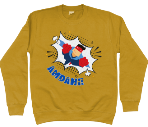 Children's sweatshirt in mustard with a colorful front graphic print featuring a superhero character and the Welsh word 'amdani'.