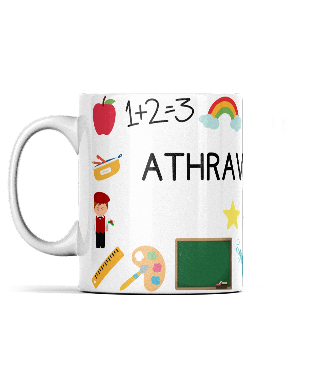 A white ceramic mug with a wraparound design featuring Welsh text, an apple, a paintbrush, and a chalkboard.