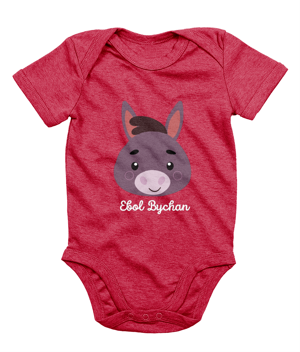 Red babygrow with a graphic of a donkey's face and the text 'Ebol Bychan' printed on the front.