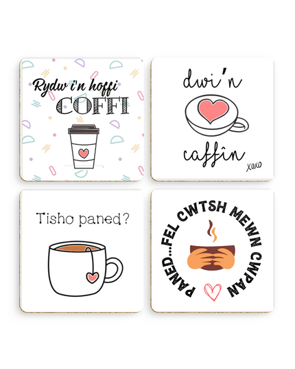 A set of four square coasters with rounded edges, each featuring a different Welsh language phrase about coffee and tea, with corresponding English translations and imagery like cups and hearts.