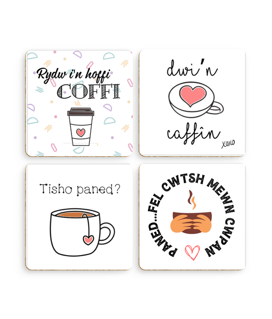 A set of four square coasters with rounded edges, each featuring a different Welsh language phrase about coffee and tea, with corresponding English translations and imagery like cups and hearts.