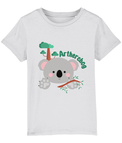 Children's t-shirt with a graphic of a koala bear and the text 'Artherchog'. The t-shirt is lavender, and the graphic includes a small green tree.