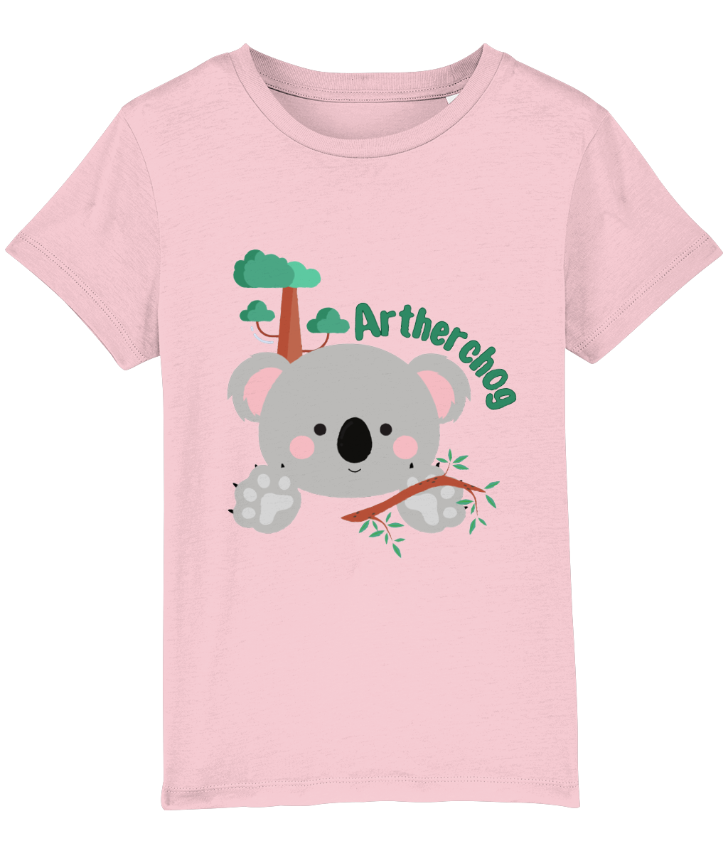 Children's t-shirt with a graphic of a koala bear and the text 'Artherchog'. The t-shirt is pink, and the graphic includes a small green tree.