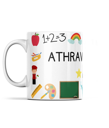 A white ceramic mug with a wraparound design featuring Welsh text, an apple, a paintbrush, and a chalkboard.