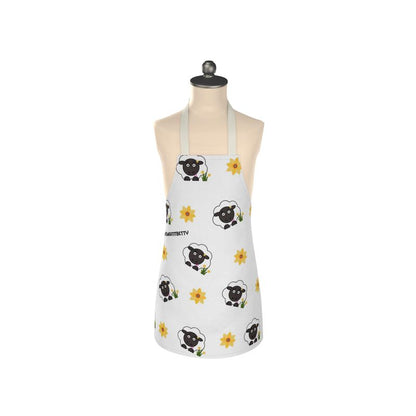A white apron with a floral pattern featuring black sheep designs, displayed on a mannequin.
