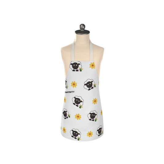 A white apron with a floral pattern featuring black sheep designs, displayed on a mannequin.