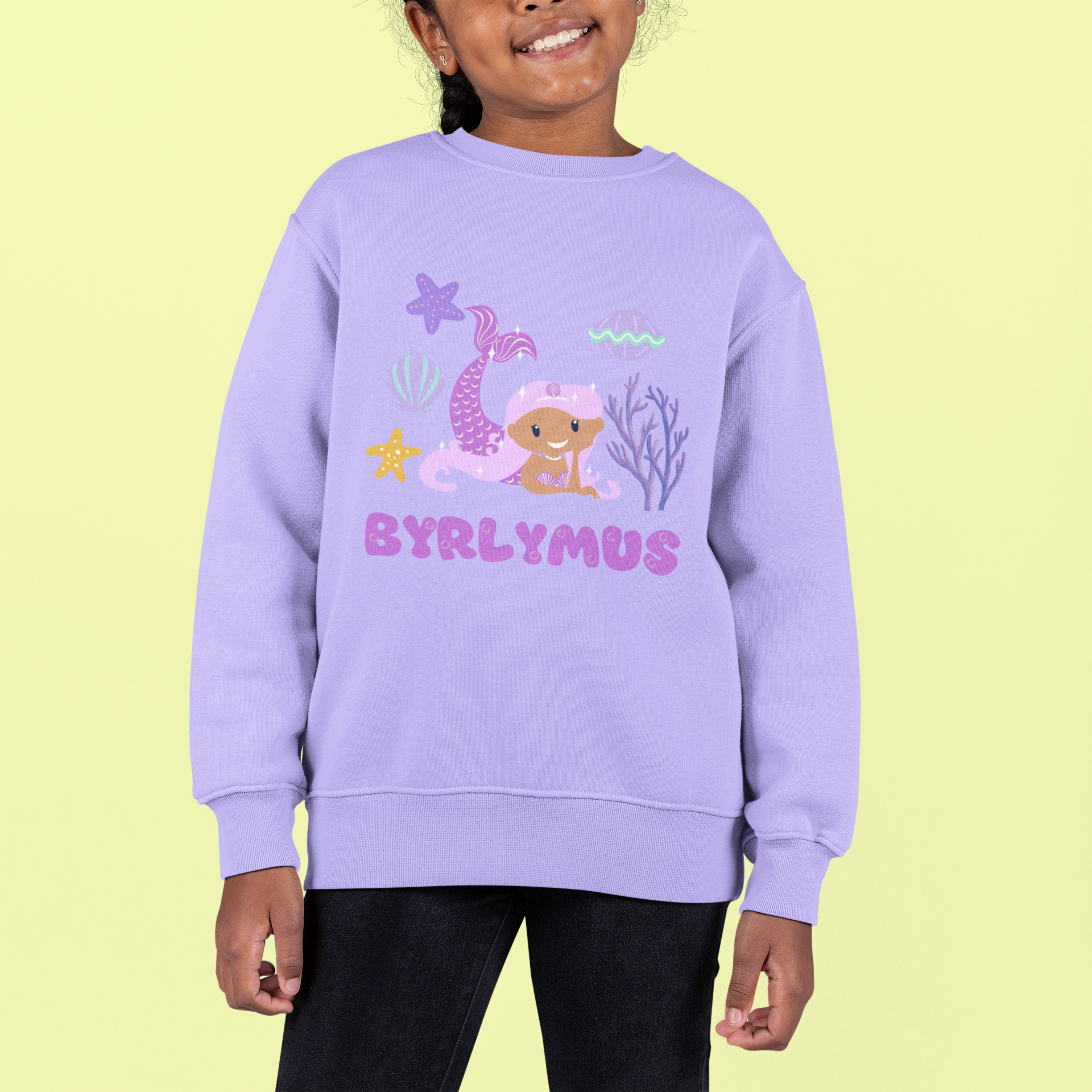 A child wearing a purple sweatshirt with the text 'BYRLYMUS' and a purple mermaid graphic.