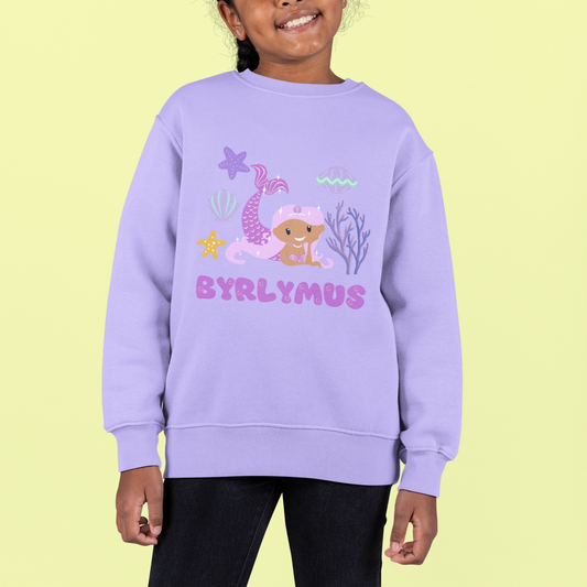 A child wearing a purple sweatshirt with the text 'BYRLYMUS' and a purple mermaid graphic.