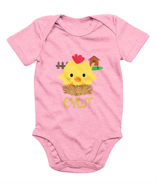 A pink babygrow with a illustration of a baby chick and the text 'CYWT' on the front.