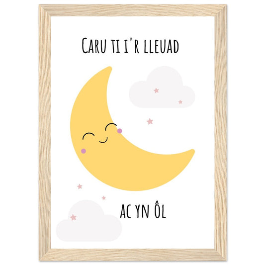 A wooden framed poster featuring a cartoon moon with the Welsh phrase 'Caru ti i'r lleuad ac yn ol' and stars, set on a white background.