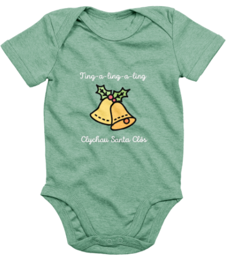A green babygrow with the text 'Clychau Santa Clôs' printed on it, featuring a graphic of Santa's bells.
