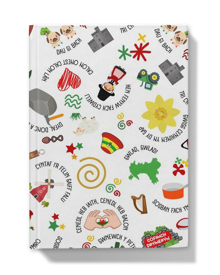 A hardback journal with a colorful cover featuring playful Welsh idioms and symbols.