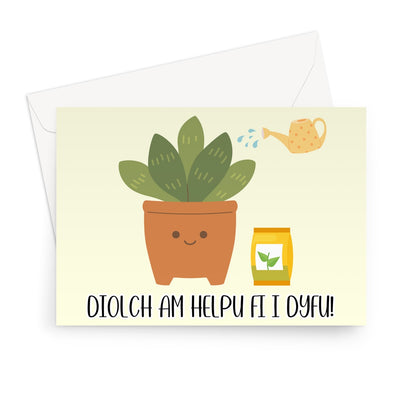 A greeting card with an illustration of a smiling plant in a pot, with a watering can and a packet of seeds. The card has a message in Welsh 'Diolch am helpu fi i dyfu!' printed on it.