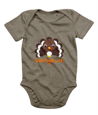 A gray baby bodysuit with a graphic of a Thanksgiving turkey and the text 'Diolchgarwch' printed on the front.