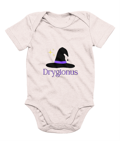 A baby pink babygrow with the text 'Drygionus' printed on it, featuring a small graphic of a witch's hat centered on the chest area.