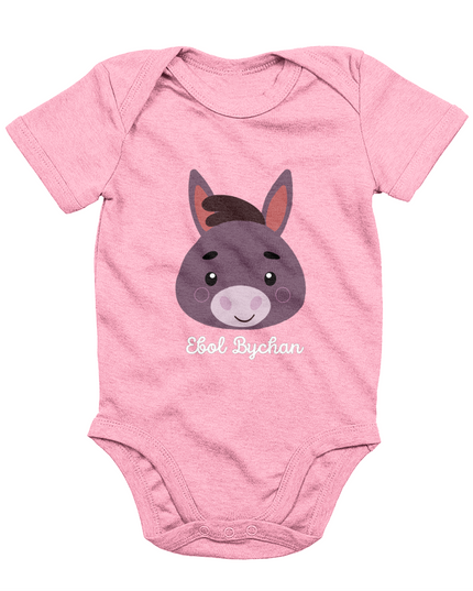Pink babygrow with a graphic of a donkey's face and the text 'Ebol Bychan' printed on the front.