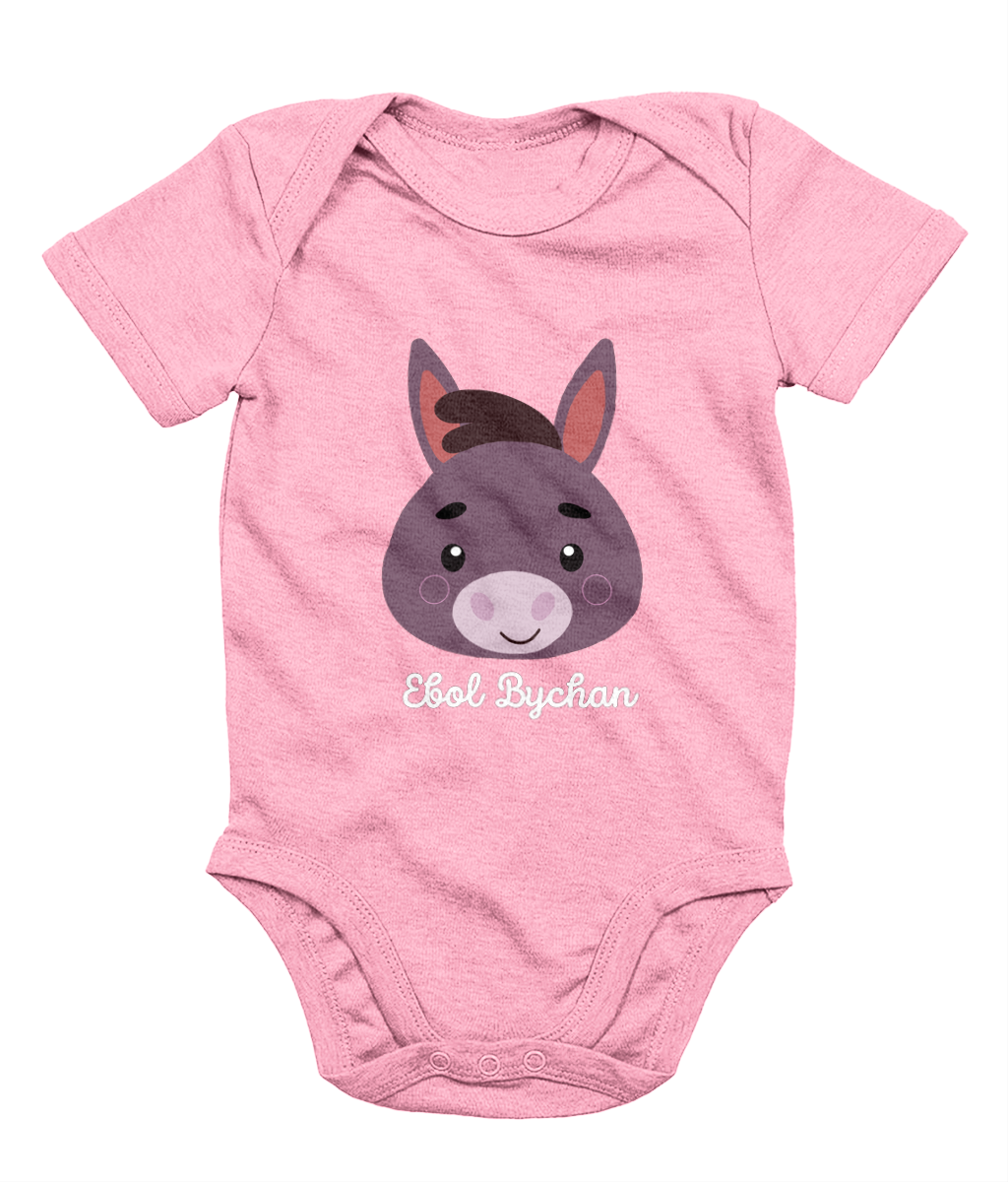 Pink babygrow with a graphic of a donkey's face and the text 'Ebol Bychan' printed on the front.