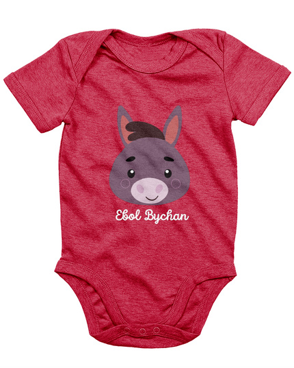 Red babygrow with a graphic of a donkey's face and the text 'Ebol Bychan' printed on the front.