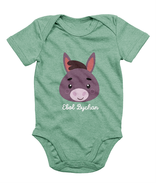 Green babygrow with a graphic of a donkey's face and the text 'Ebol Bychan' printed on the front.