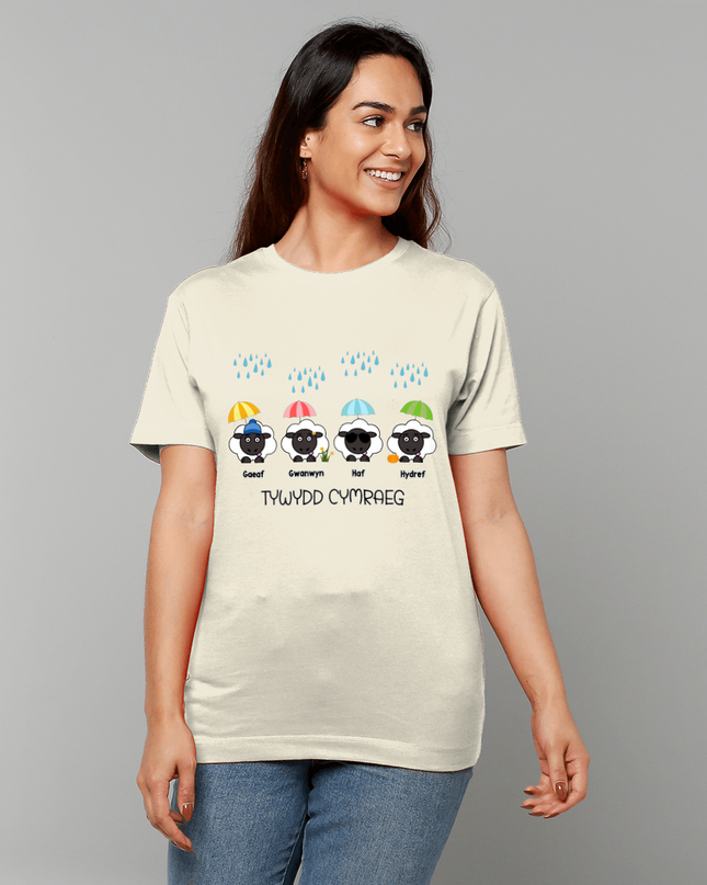 Woman wearing a beige t-shirt with colorful sheep graphics and text on a gray background
