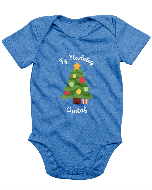 A blue babygro with 'Fy Nadolig Cyntaf' printed in Welsh, featuring a Christmas tree motif.