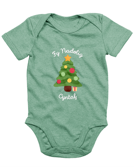 A green babygro with 'Fy Nadolig Cyntaf' printed in Welsh, featuring a Christmas tree motif.