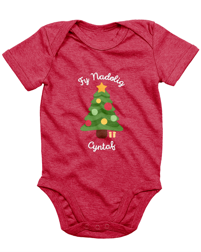 A red babygro with 'Fy Nadolig Cyntaf' printed in Welsh, featuring a Christmas tree motif.