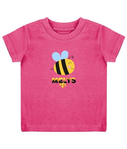 A pink child's T-shirt with a graphic of a bee and the name 'Melys' printed below it.