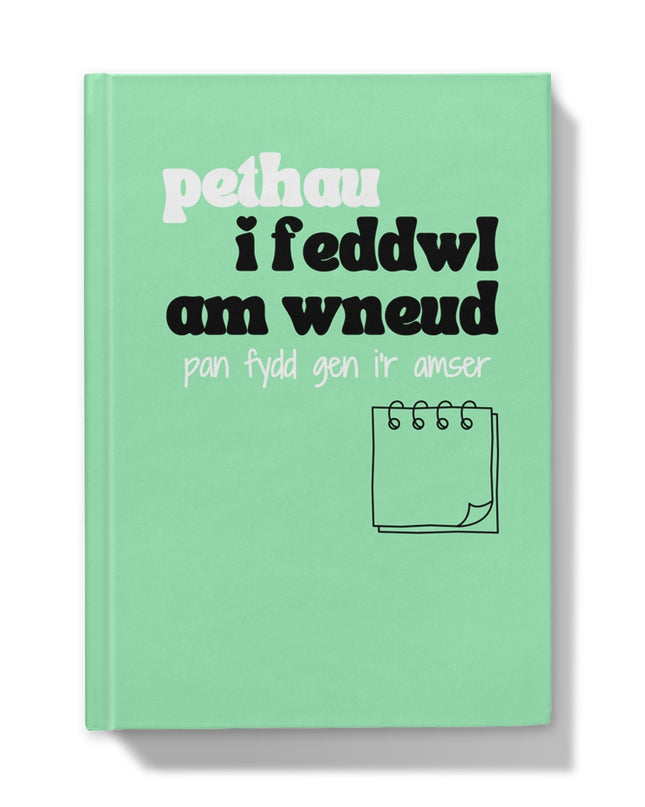 A green hardback journal with Welsh text on the cover, translates to Things 'I'm thinking about doing when I have the time'.