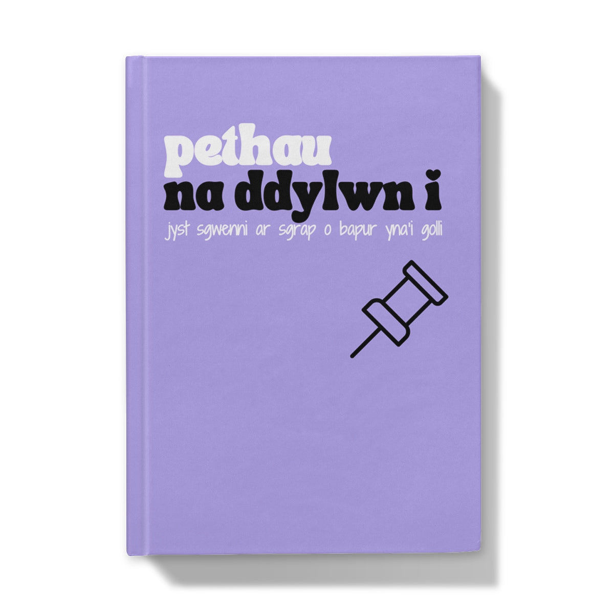 A purple hardback journal with Welsh text on the cover, translates to 'things I shouldn't write on a scrap of paper then lose'.