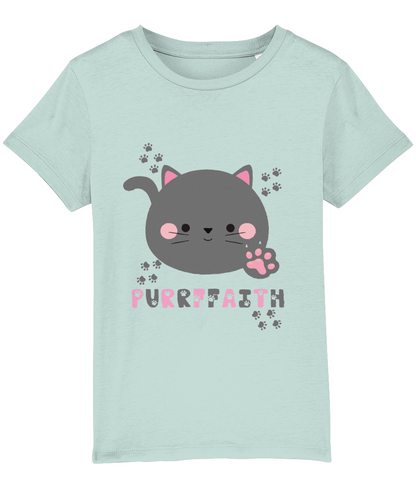 A light-colored girls' t-shirt with a graphic of a cartoon cat and the text 'Purrffaith'. The shirt is designed for children and is organic cotton.