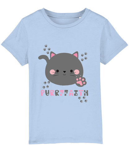 A light-colored girls' t-shirt with a graphic of a cartoon cat and the text 'Purrffaith'. The shirt is designed for children and is organic cotton.