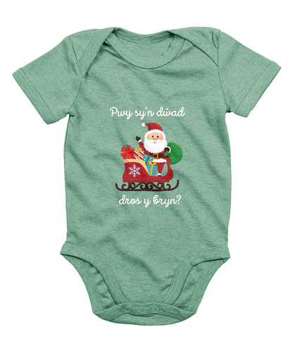 Green sleeveless babygrow with a festive Welsh phrase and Christmas-themed graphics including Santa Claus.
