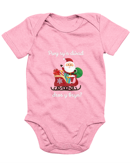 Pink sleeveless babygrow with a festive Welsh phrase and Christmas-themed graphics including Santa Claus.