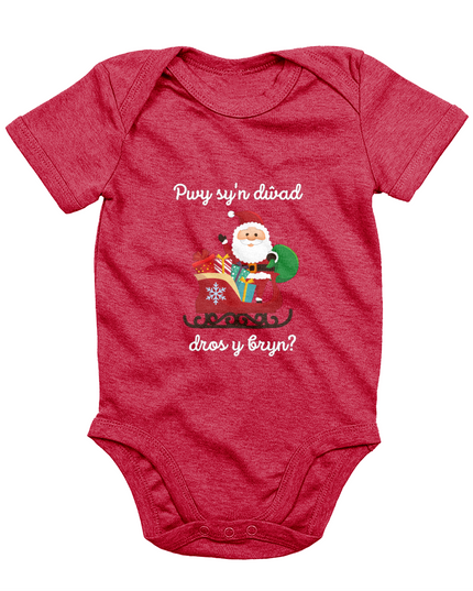 Red sleeveless babygrow with a festive Welsh phrase and Christmas-themed graphics including Santa Claus.