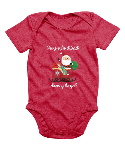 Red sleeveless babygrow with a festive Welsh phrase and Christmas-themed graphics including Santa Claus.