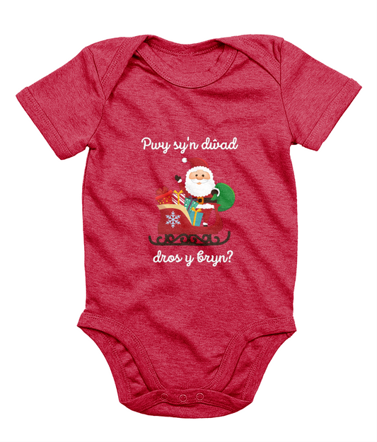 Red sleeveless babygrow with a festive Welsh phrase and Christmas-themed graphics including Santa Claus.