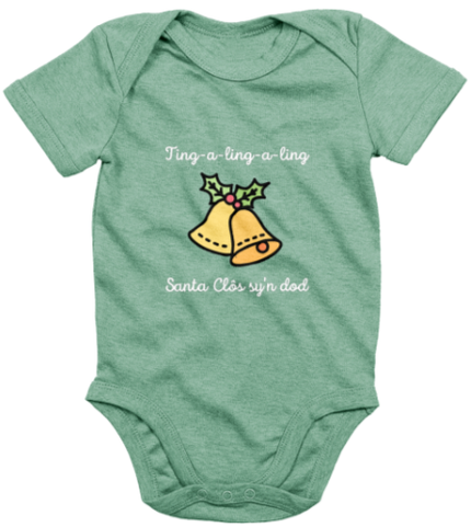 A green babygrow with 'Santa Clôs sy'n dod ' printed in bold lettering, featuring an image of Santa Claus's sleigh bells.