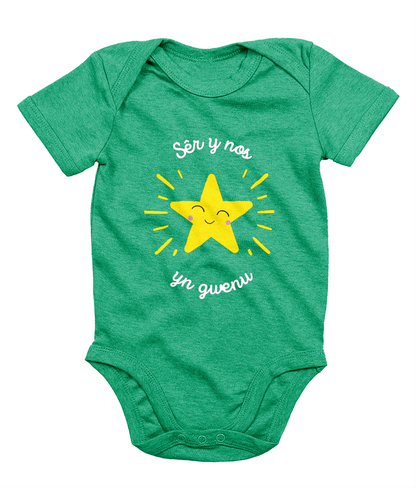 Welsh Christmas-themed babygrow with the phrase 'Sér y Nos yn Gwenu' printed on it, featuring a smiling star graphic.