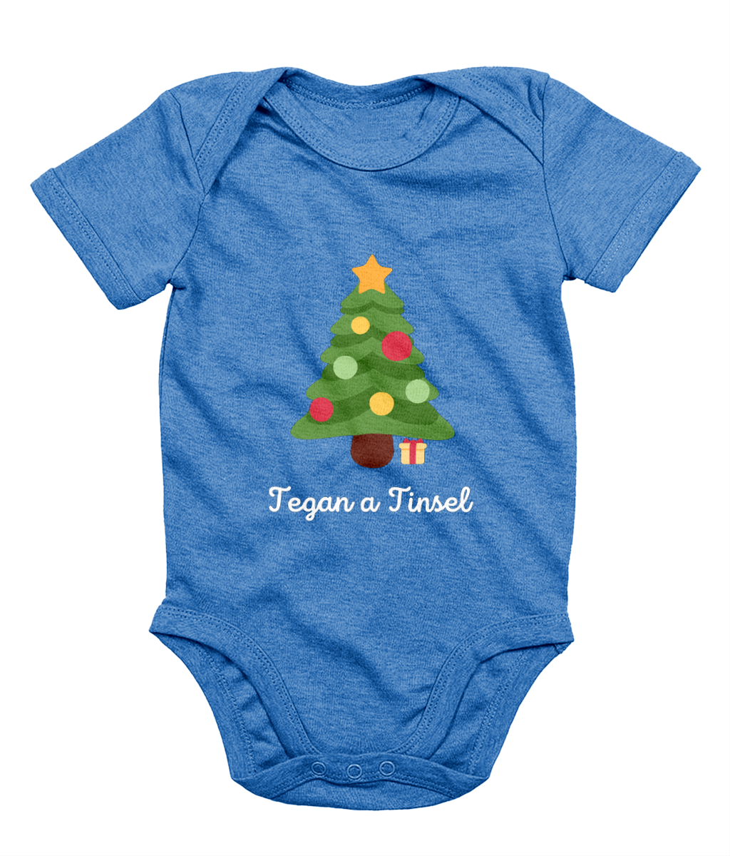 Blue Welsh Christmas-themed babygrow with a Christmas tree and gifts design, and the text 'Tegannau a Tinsel' printed on the front.