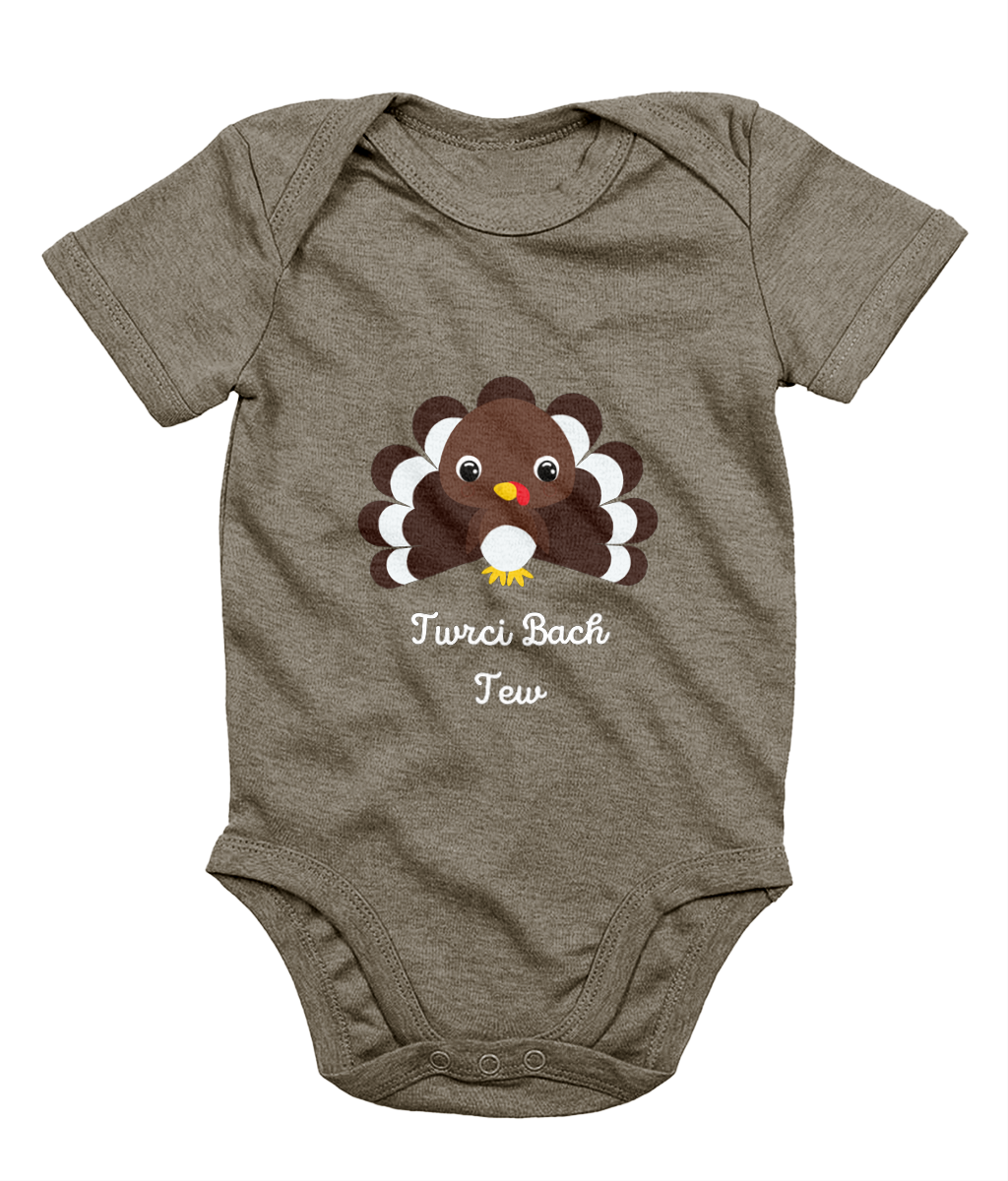 A gray Welsh babygrow with a festive design featuring a character resembling a turkey and the text 'Twrci Bach Tew'.